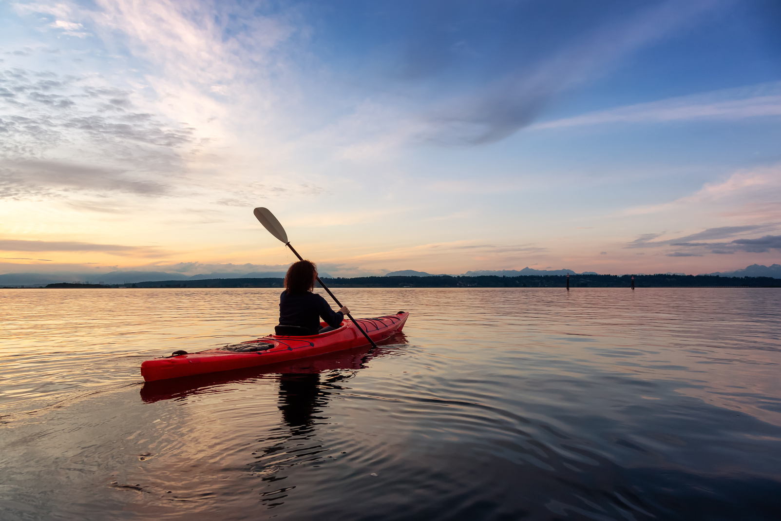 Person Kayaking at Sunset